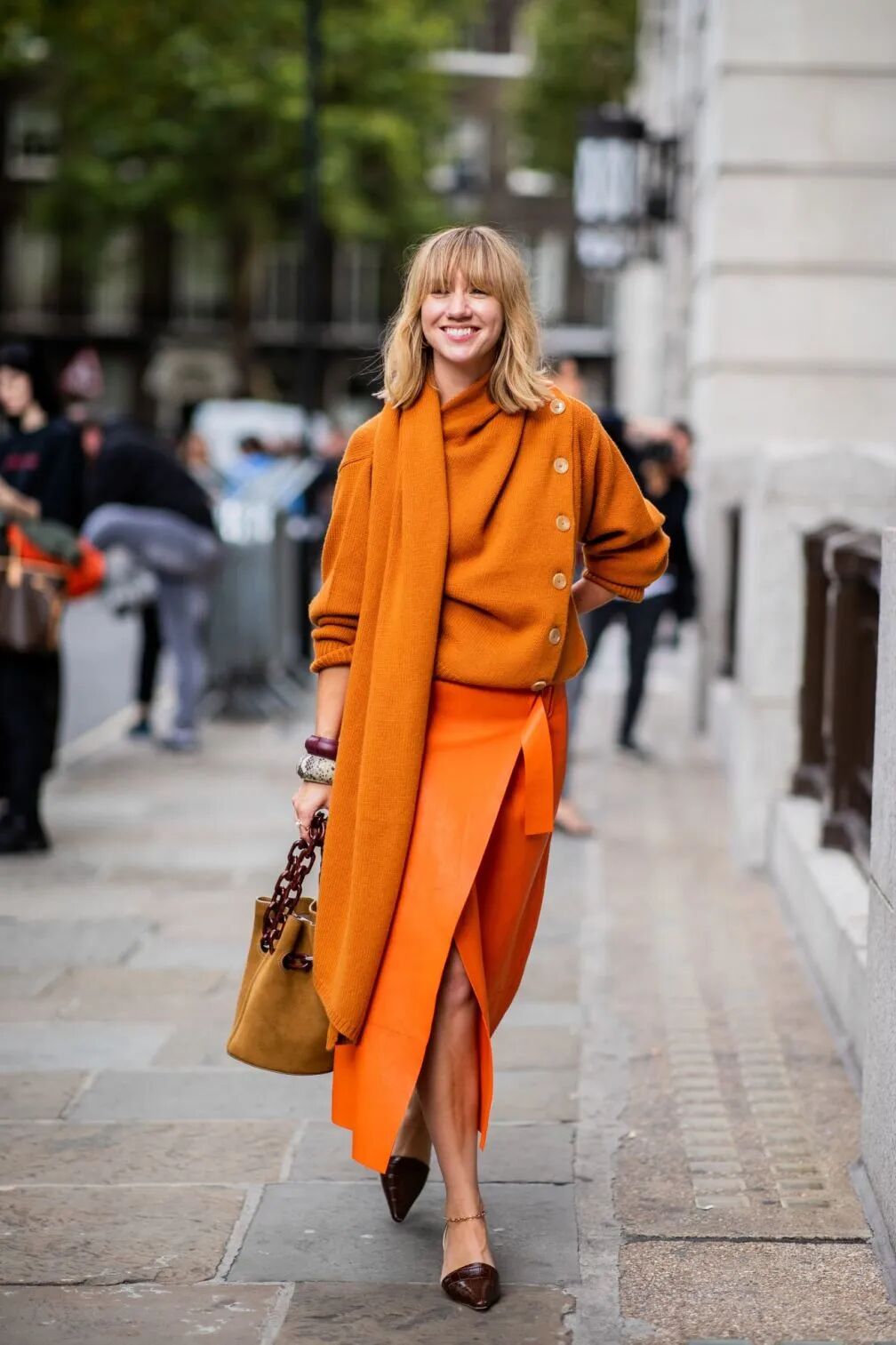 Orange knitwear and wrap skirt used as an apricot color reference for apparel collection development