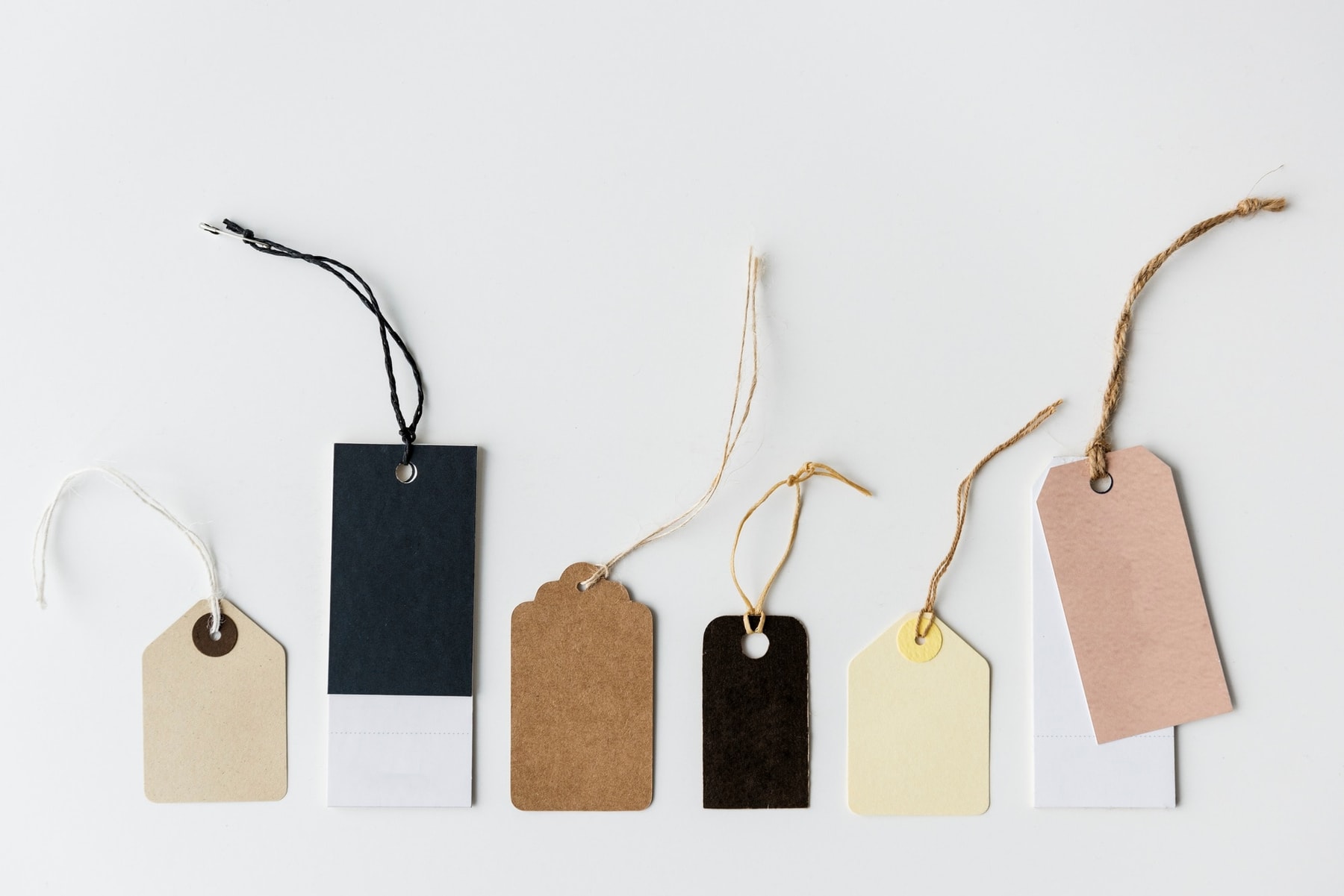 Blank hangtags with different cords, shapes and attachment holes for checking label components against an approved specification