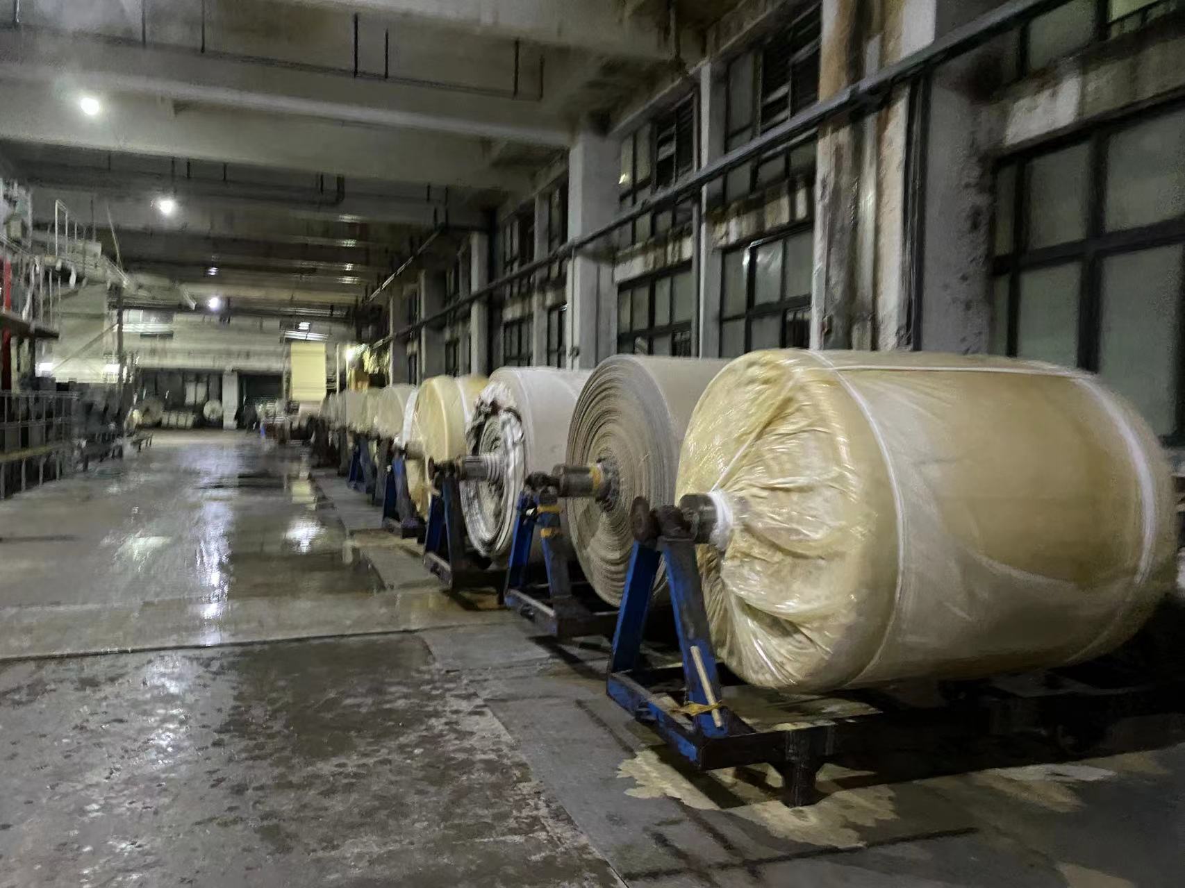 Prepared fabric rolls staged after refining at a Yinshan Fashion partner fabric factory