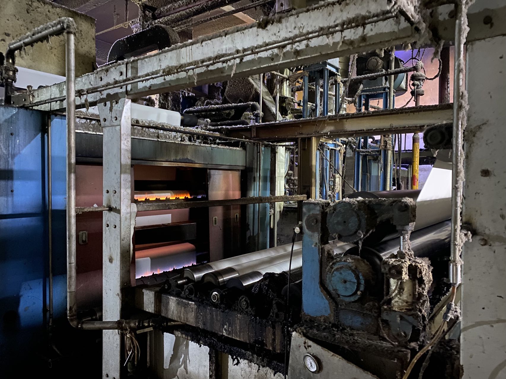 Fabric passing through a singeing line at a Yinshan Fashion partner fabric factory