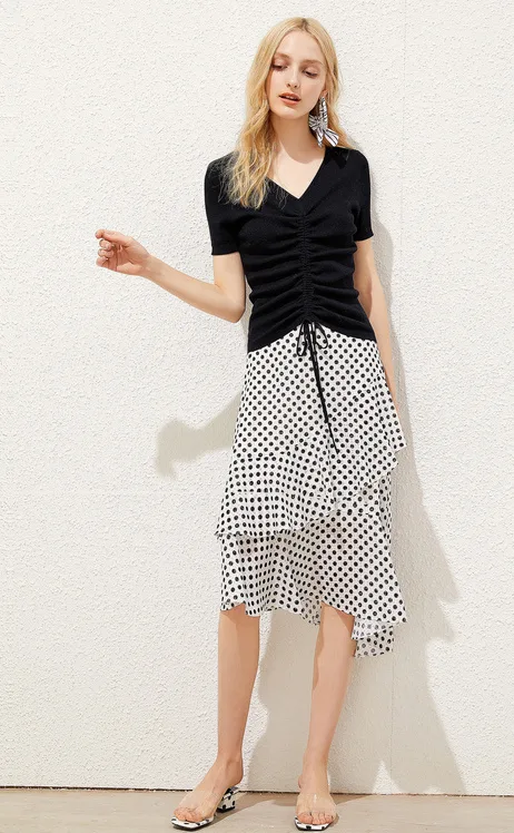 Black ruched drawcord V-neck knit jersey top paired with a polka dot skirt
