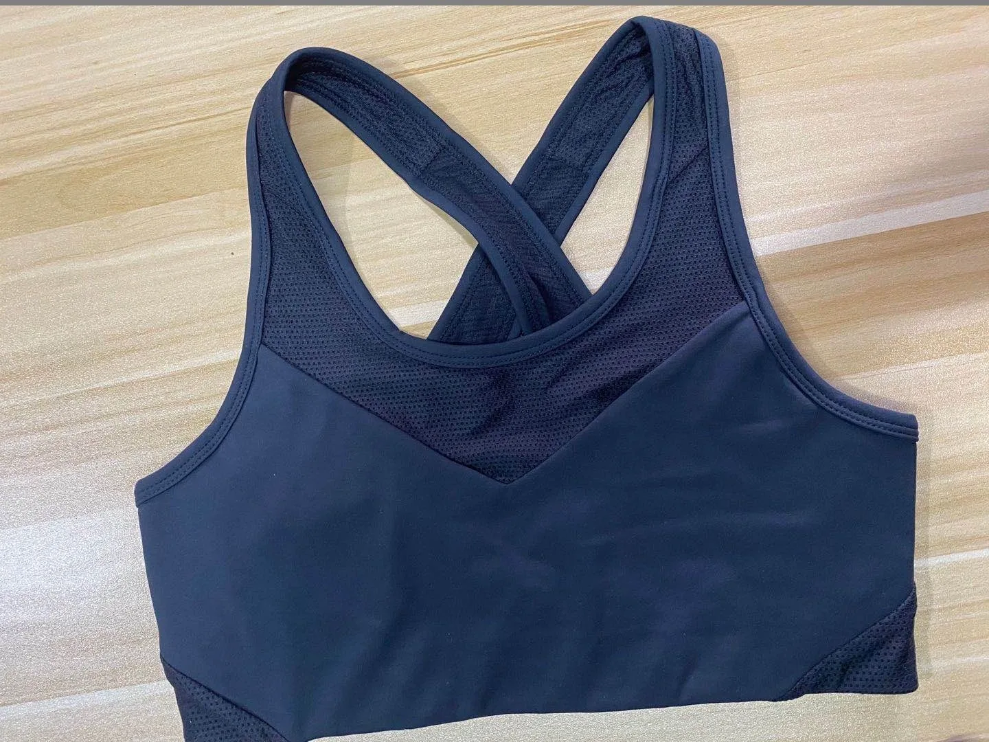 Unbranded navy racerback sports bra laid flat for activewear construction and fabric review