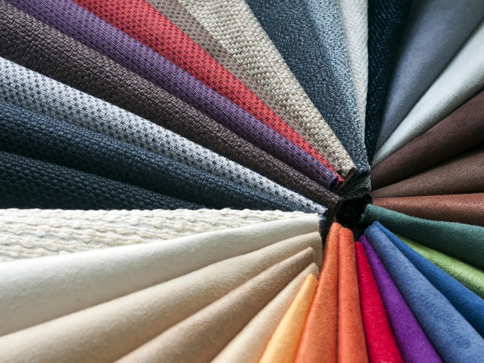 Close-up of woven fabric swatches in multiple colours, illustrating material and colourway choices for MOQ planning