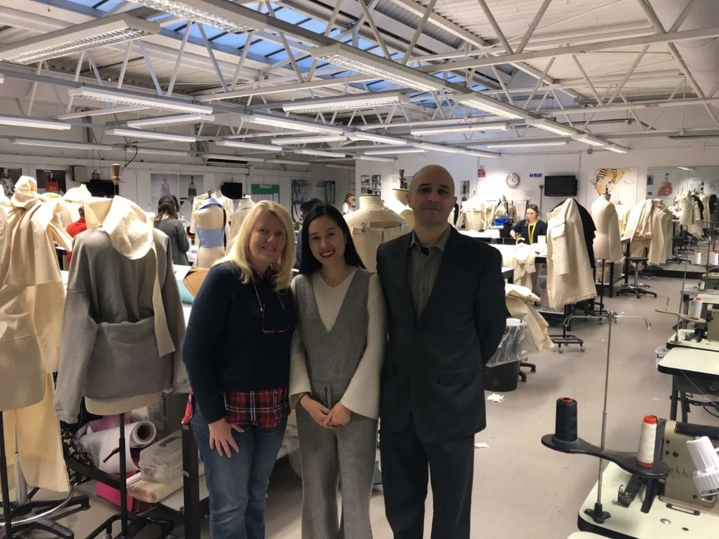 Apparel development team visiting a sample room with dress forms and garments