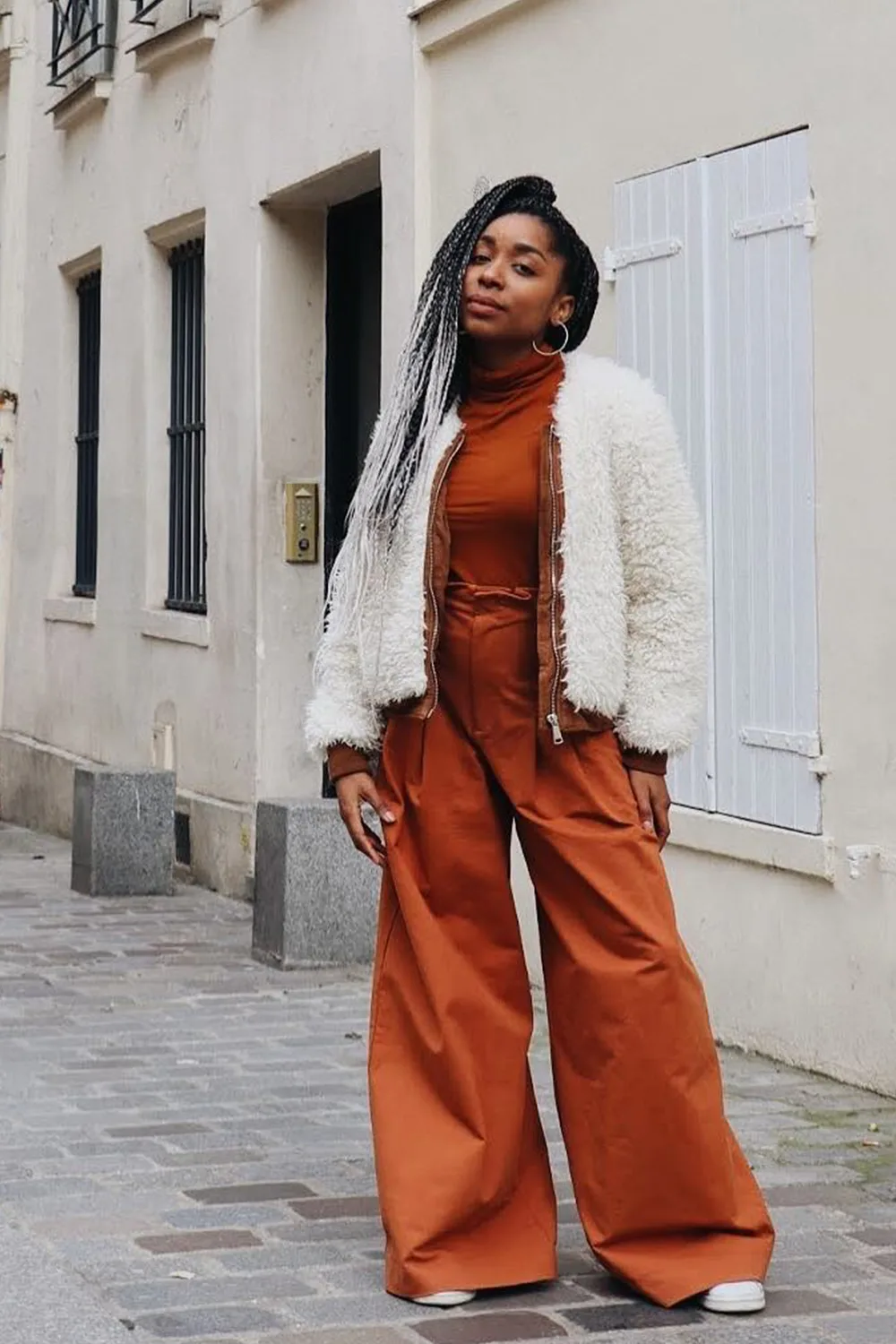 Warm oxidized orange wide-leg trousers used as an apparel color-development reference