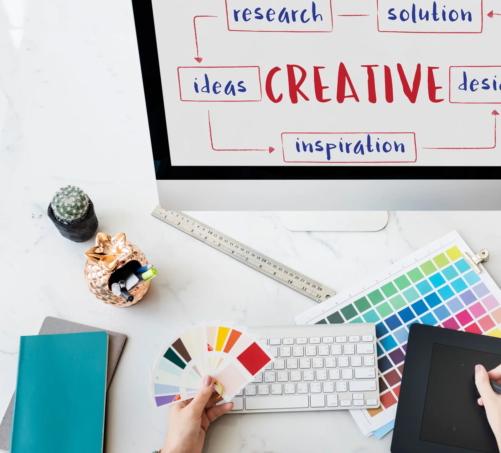 Creative planning desk with colour cards and material references for an apparel brief