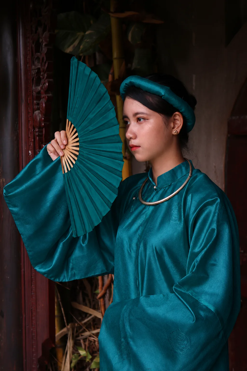 Peacock green dress and fan used as a jewel-tone fashion color-development reference