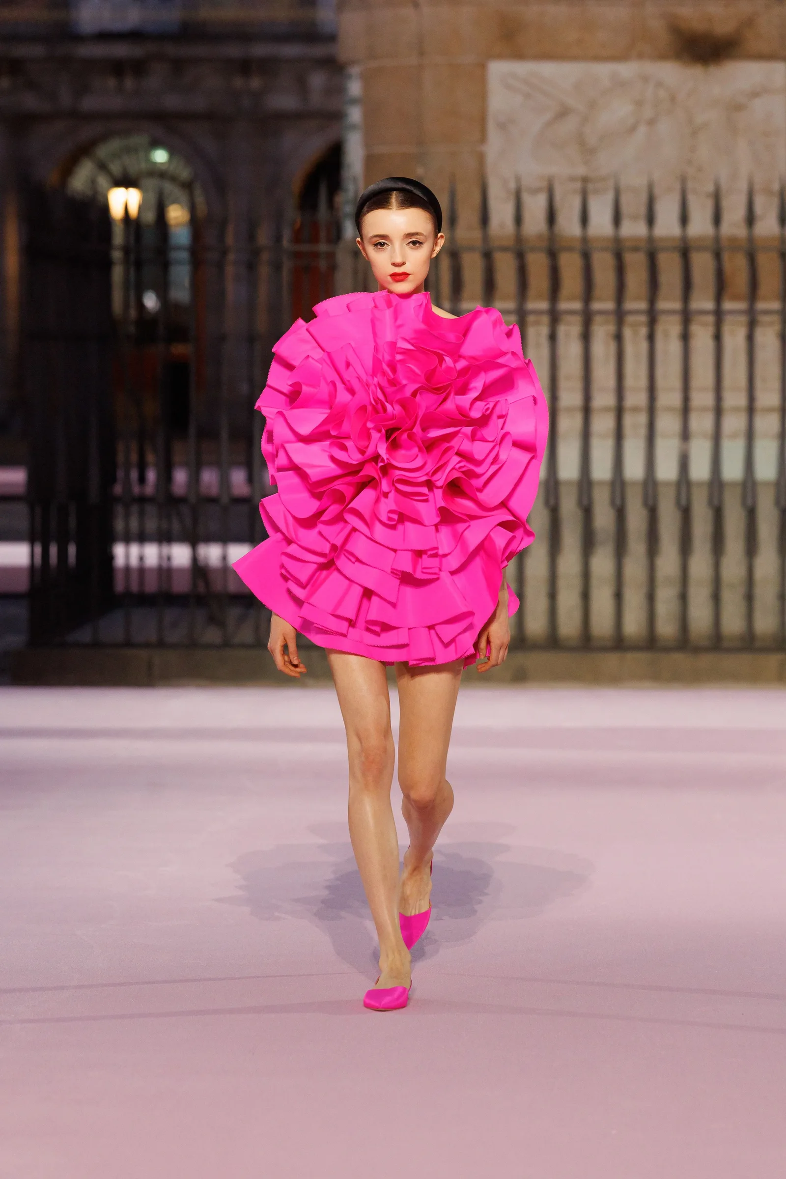 Bright pink ruffled dress used as an apparel color-development reference