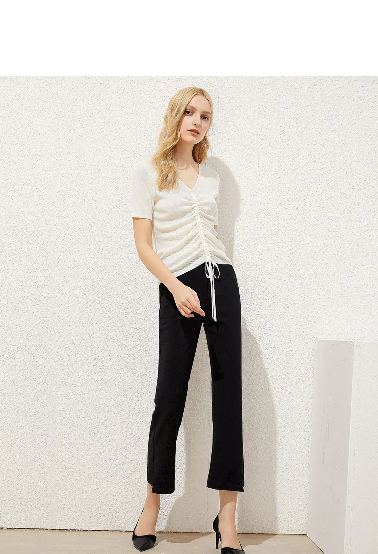 Ivory gathered V-neck knit tee styled with black trousers