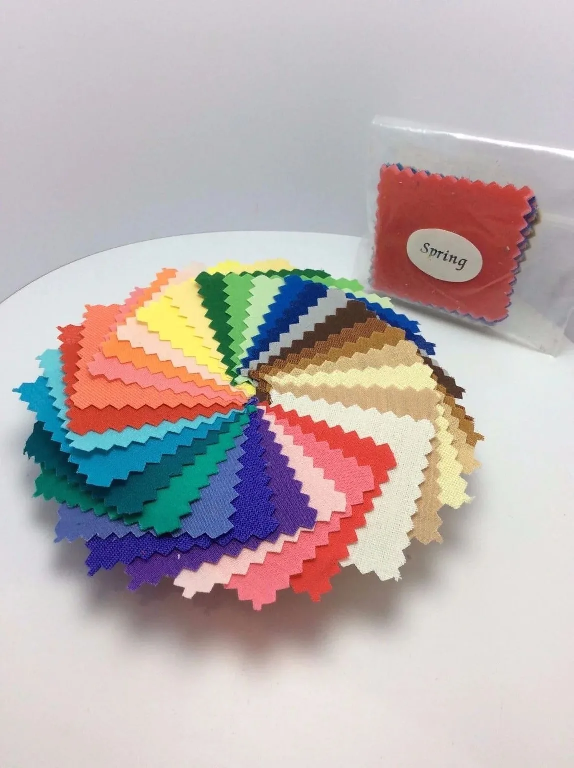 Physical fabric swatches arranged by colour as references for material and colour approval
