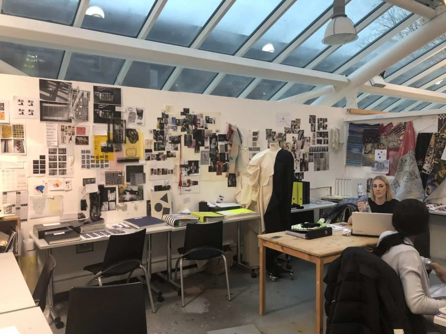 Designers reviewing collection references and material choices before garment sampling