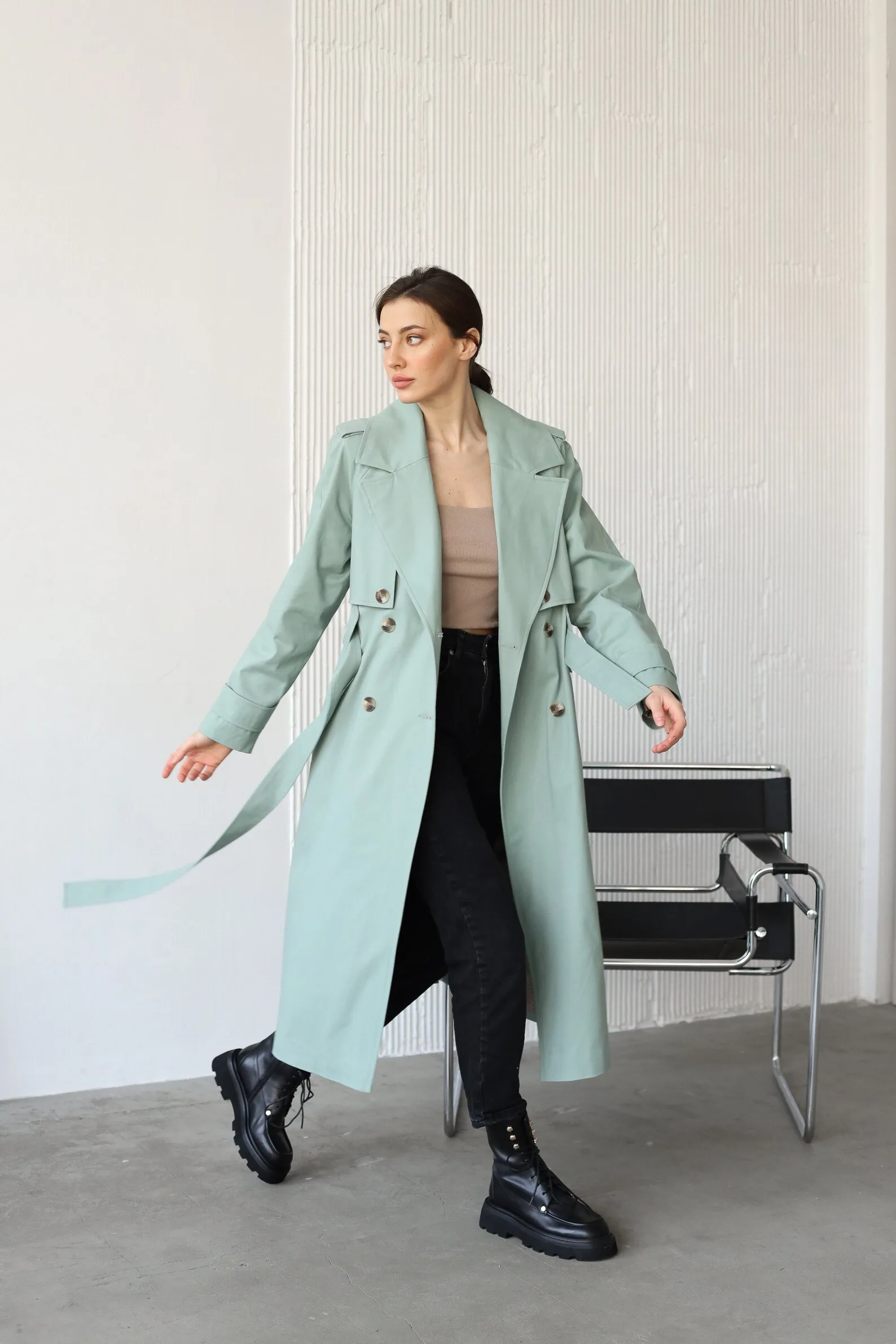 Sage-green outerwear showing how garment surface and surrounding components change a color's appearance