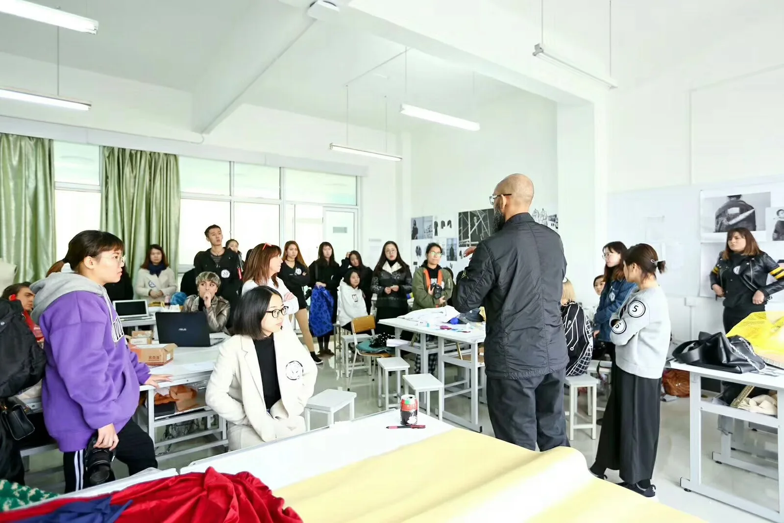 Yinshan Fashion product-development team reviewing garment materials and design direction in the sample room